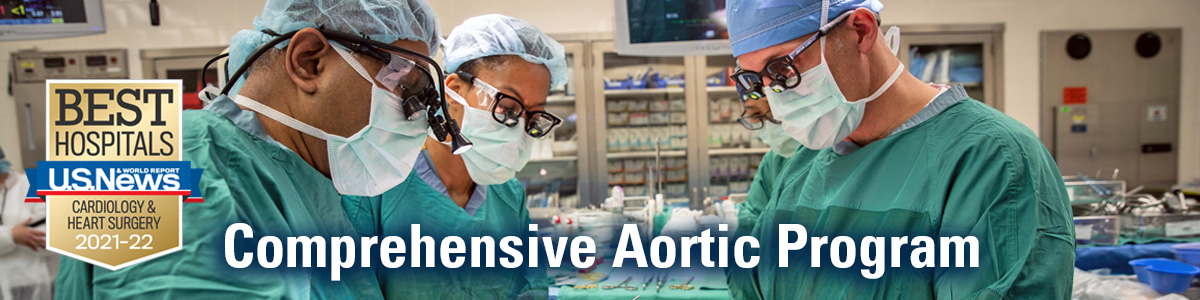 Three surgeons in operating room wearing scrubs,glasses, masks, and caps with USNWR  Best Hospitals for Cardiology & Heart Surgery badge and text Comprehensive Aortic Program in white text