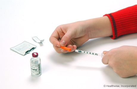 Removing the plastic cap from the needle
