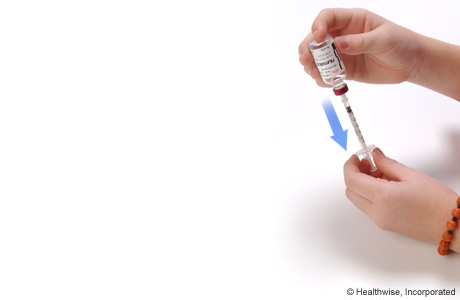 Drawing insulin into the syringe