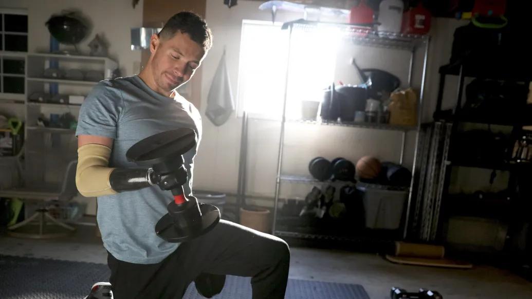 man lifting weight on knees in home gym