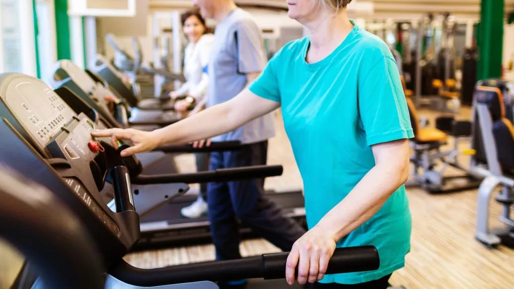 woman on treadmill with teal shirt
