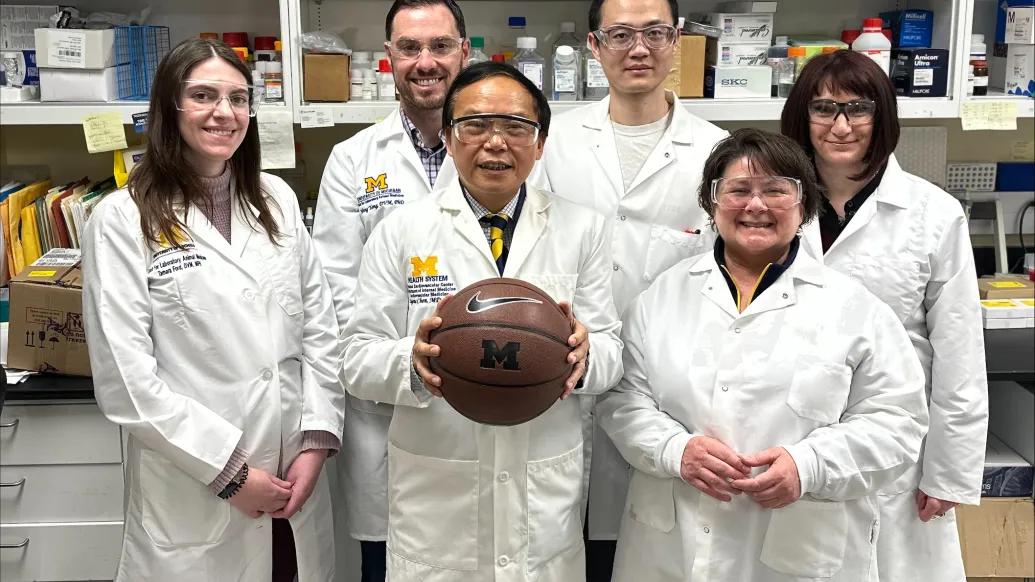Members of Eugene Chen's laboratory with a basketball