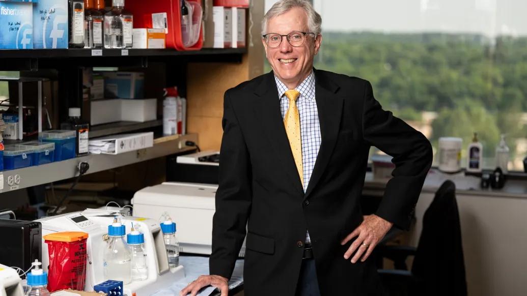 Daniel Hayes poses for a photo in a lab