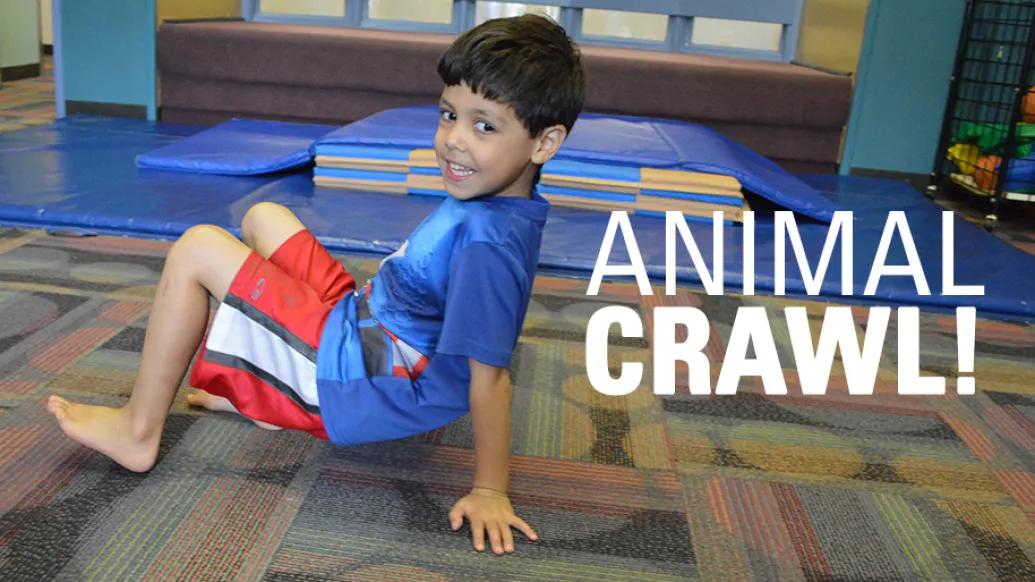 Child backwards on hands and feet posing for the animal crawl