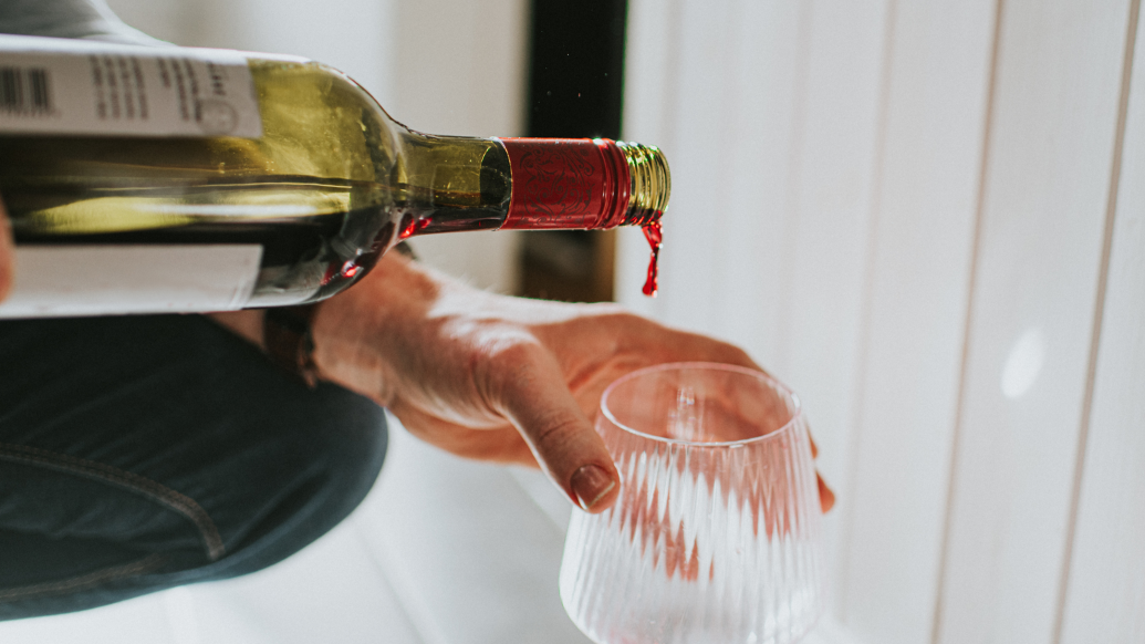 wine being poured into glass 