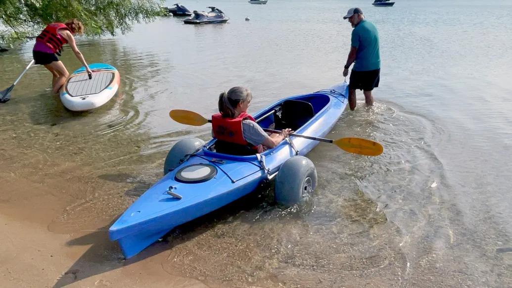 girl going in canoe with instructor in water 