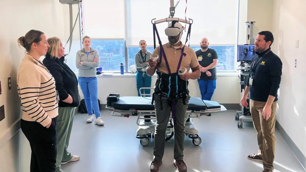 team standing around person using virtual reality headset