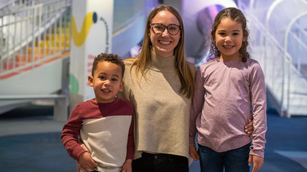 mom smiling with two kids