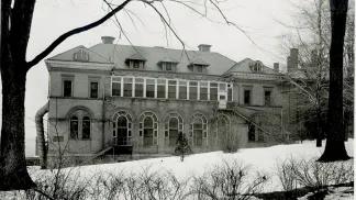 Black and white photo of the Palmer Ward for pediatrics that was part of the old University Hospital campus before "Old Main" was built in the 1930s. It's a 3-story building with large arched windows in front.