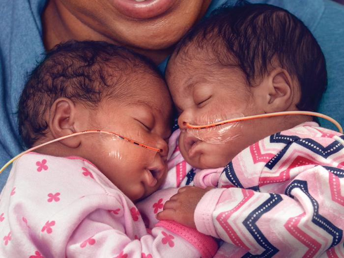 Merrick and Melliah sleeping on their mother's chest