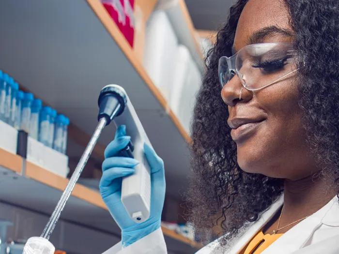Sierra works with a device in the lab