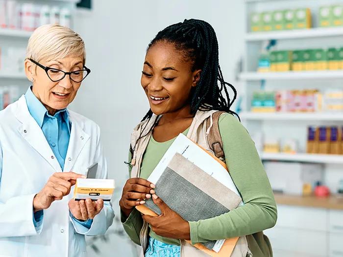 Pharmacist going over medication with patient or caregiver.