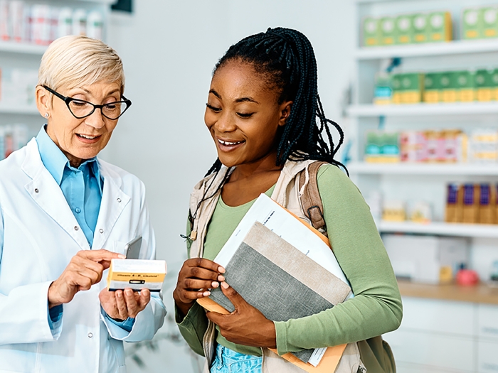 Pharmacist going over medication with patient or caregiver.