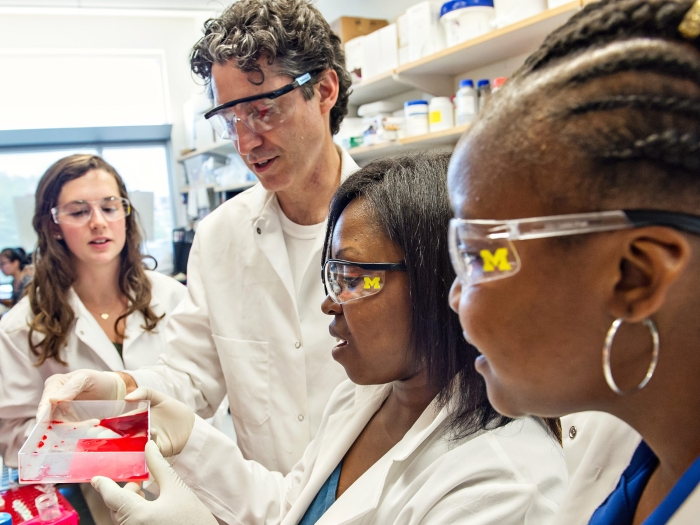 faculty and students in a lab