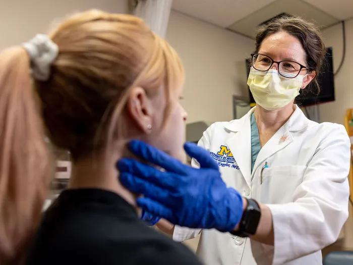 Doctor examining a patient's neck