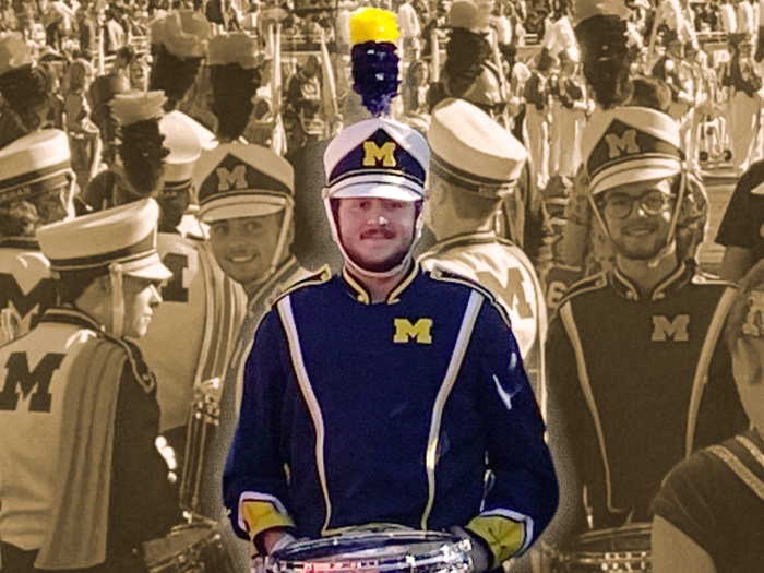 sepia tone photo off grey with band member in yellow and blue highlighted in middle