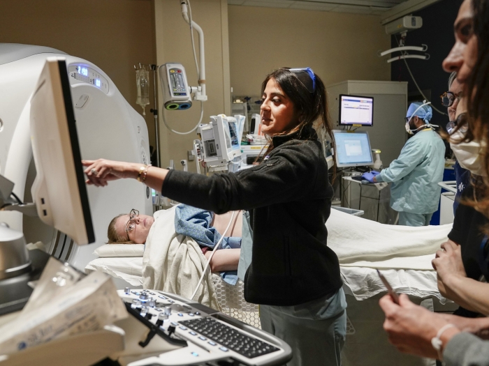 Patient receiving histotripsy treatment with health care providers using equipment