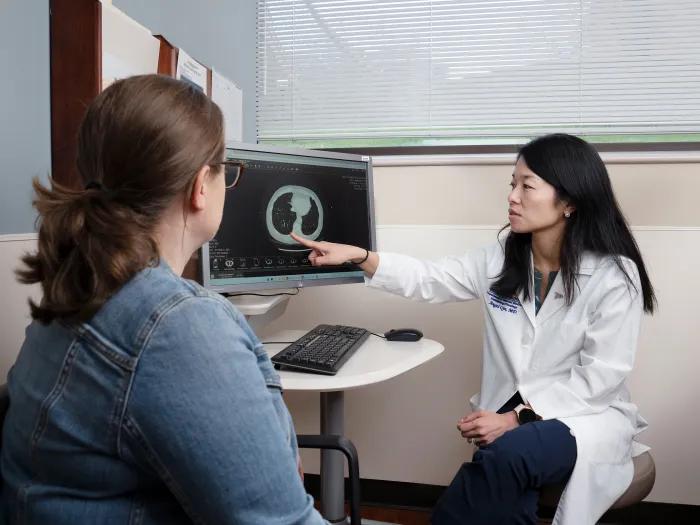Dr. Judith Tam reviewing a scan with a patient