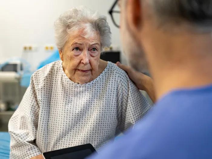 Elderly woman in hospital with provider