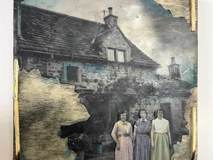 Mixed media art work of a house with three women standing in front of it.