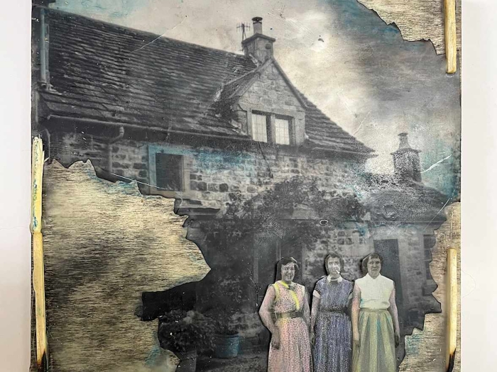 Mixed media art work of a house with three women standing in front of it.