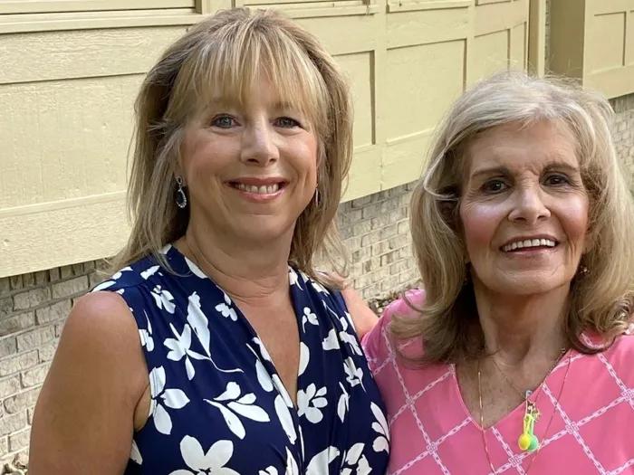 women smiling with each other for camera