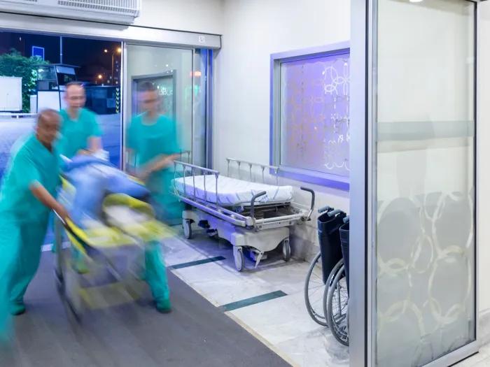 blur of hospital staff moving patient in on stretcher 