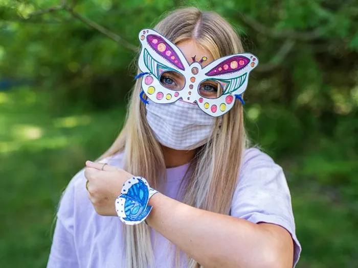 A girl wearing animal mask and bracelet.