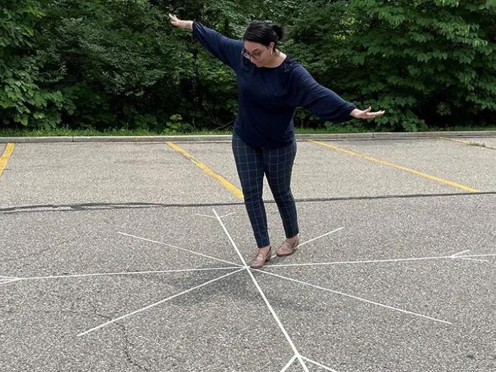 Person balancing on chalk design snowflake drawing