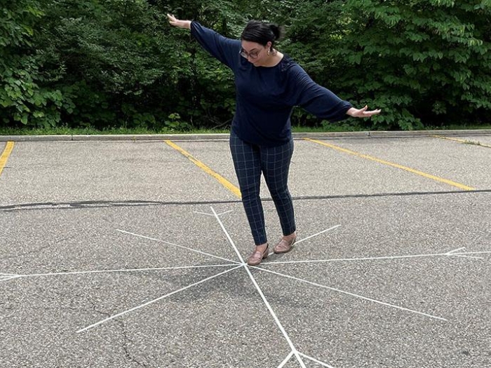 Person balancing on chalk design snowflake drawing