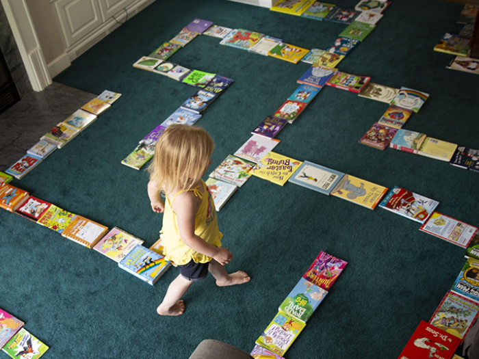 Child walking through homemade book maze