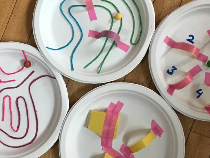 homemade pinball machine with crafts on paper plates