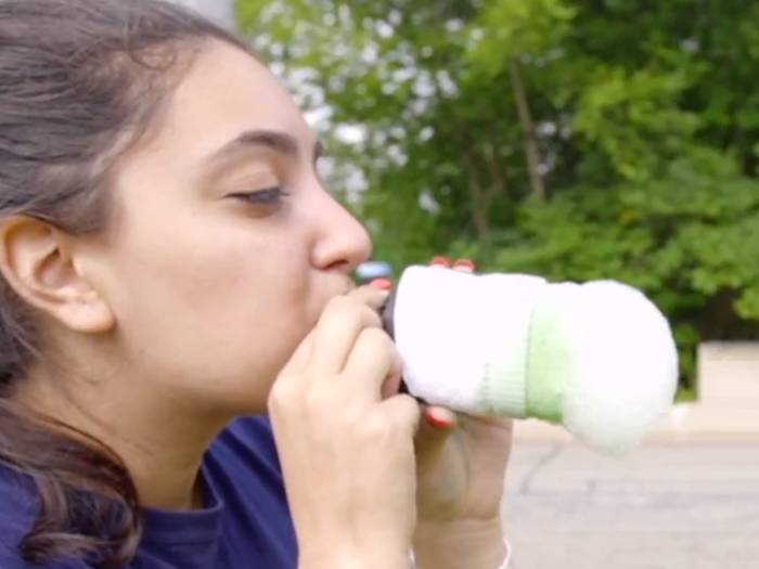 woman blowing bubbles into snake form