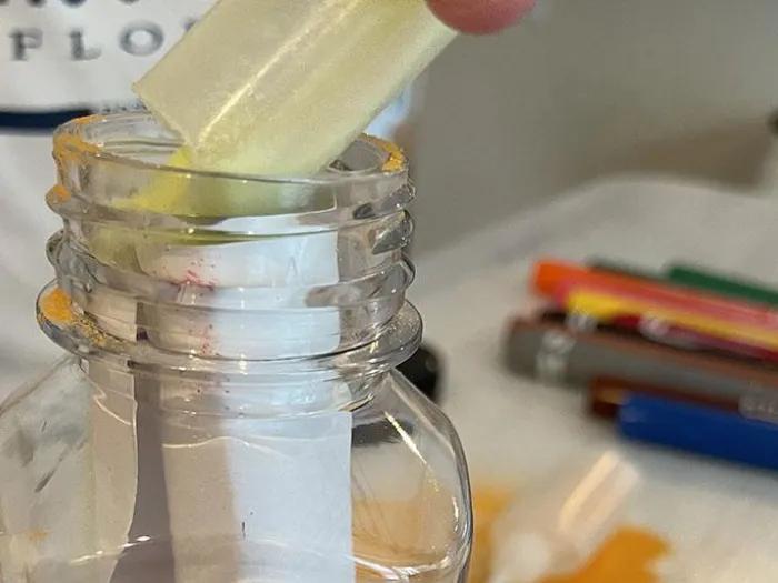 paper message rolled up and placed into a glass bottle