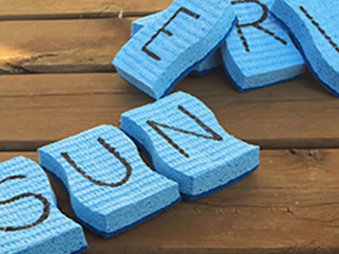 letters written on a few sponges spell SUN