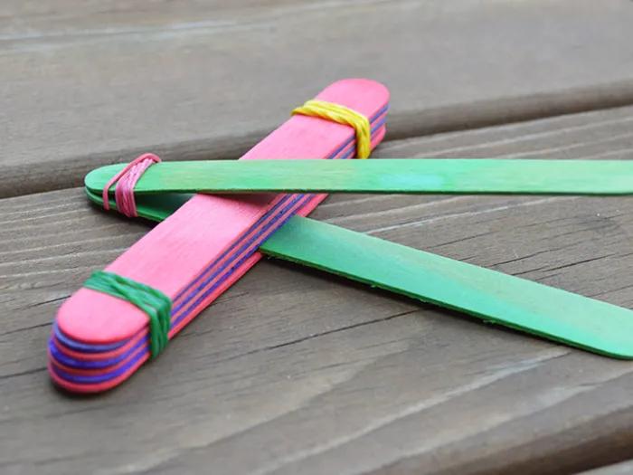 colorful popsicle sticks arranged around each other to create catapult 