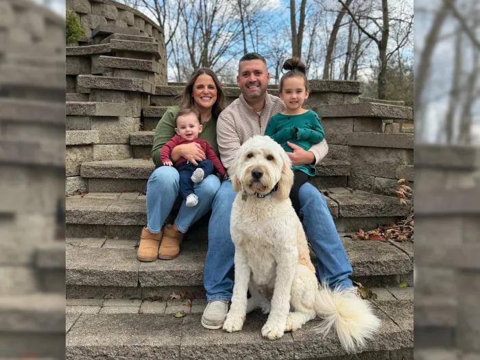 family with dog outside
