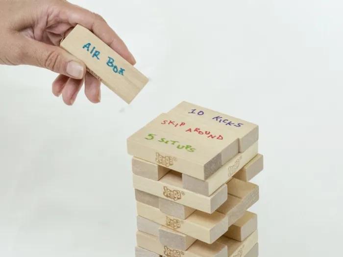 Childs hand stacking a Jenga block