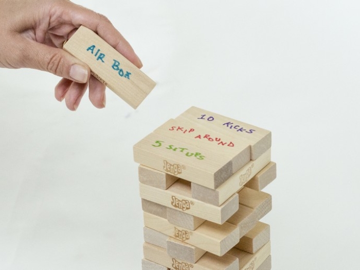 Childs hand stacking a Jenga block