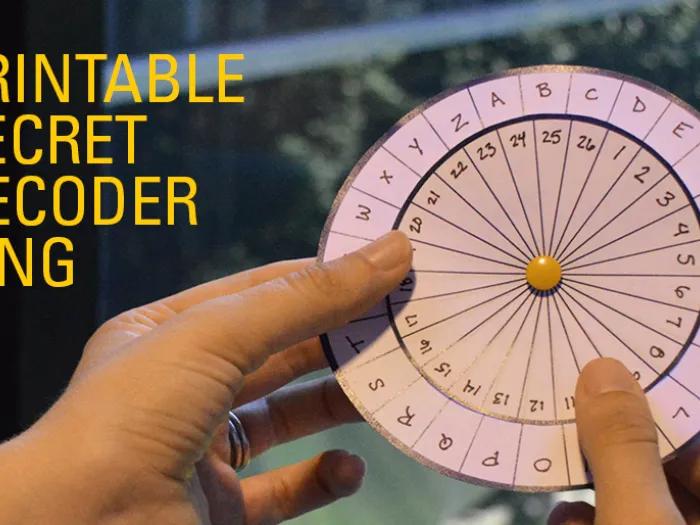 child holds paper circle secret message decoder wheel