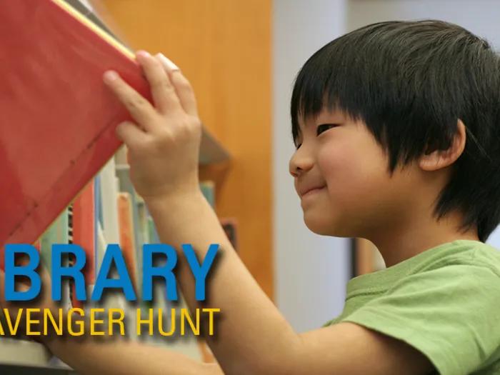 child pulls book from shelf at library