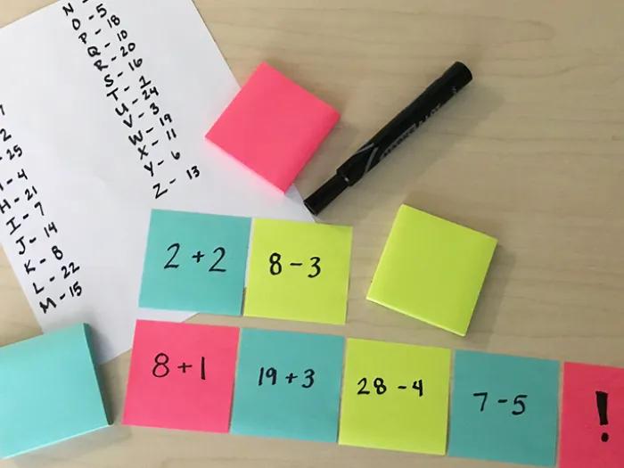colorful post-its with math equations and decoder answer key