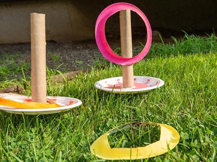 Paper plates with paper tube attached and cut out colored rings