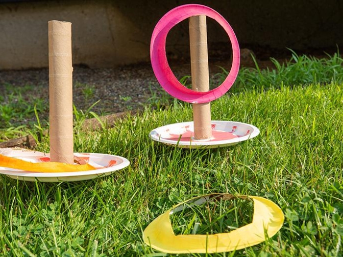 Paper plates with paper tube attached and cut out colored rings