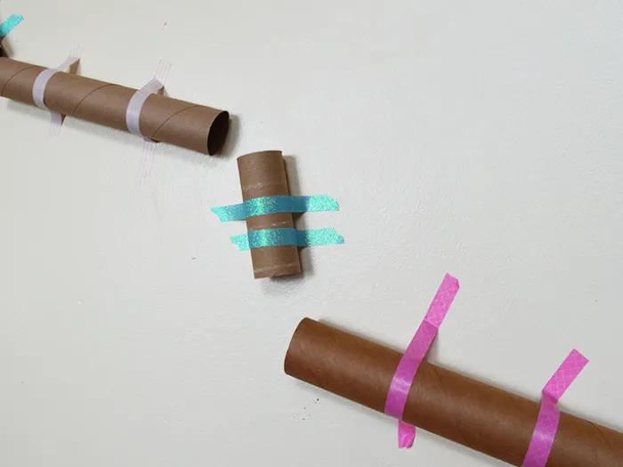 cardboard tubes arranged on wall for pom pom drop experiment