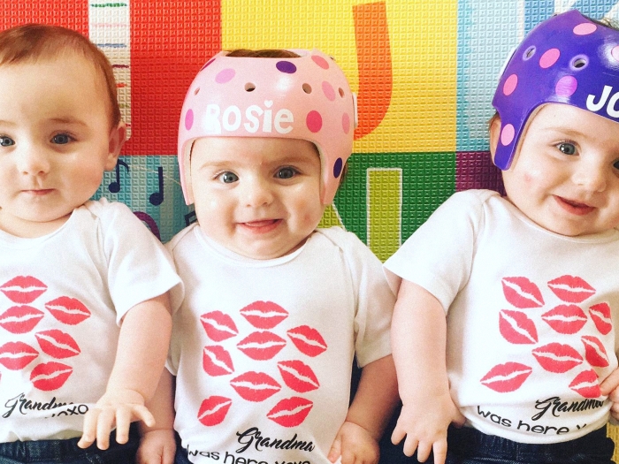 three triplets and two with head gear on with their names in pink and purple