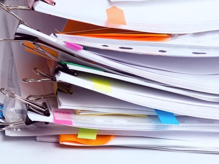 a large stack of messy papers