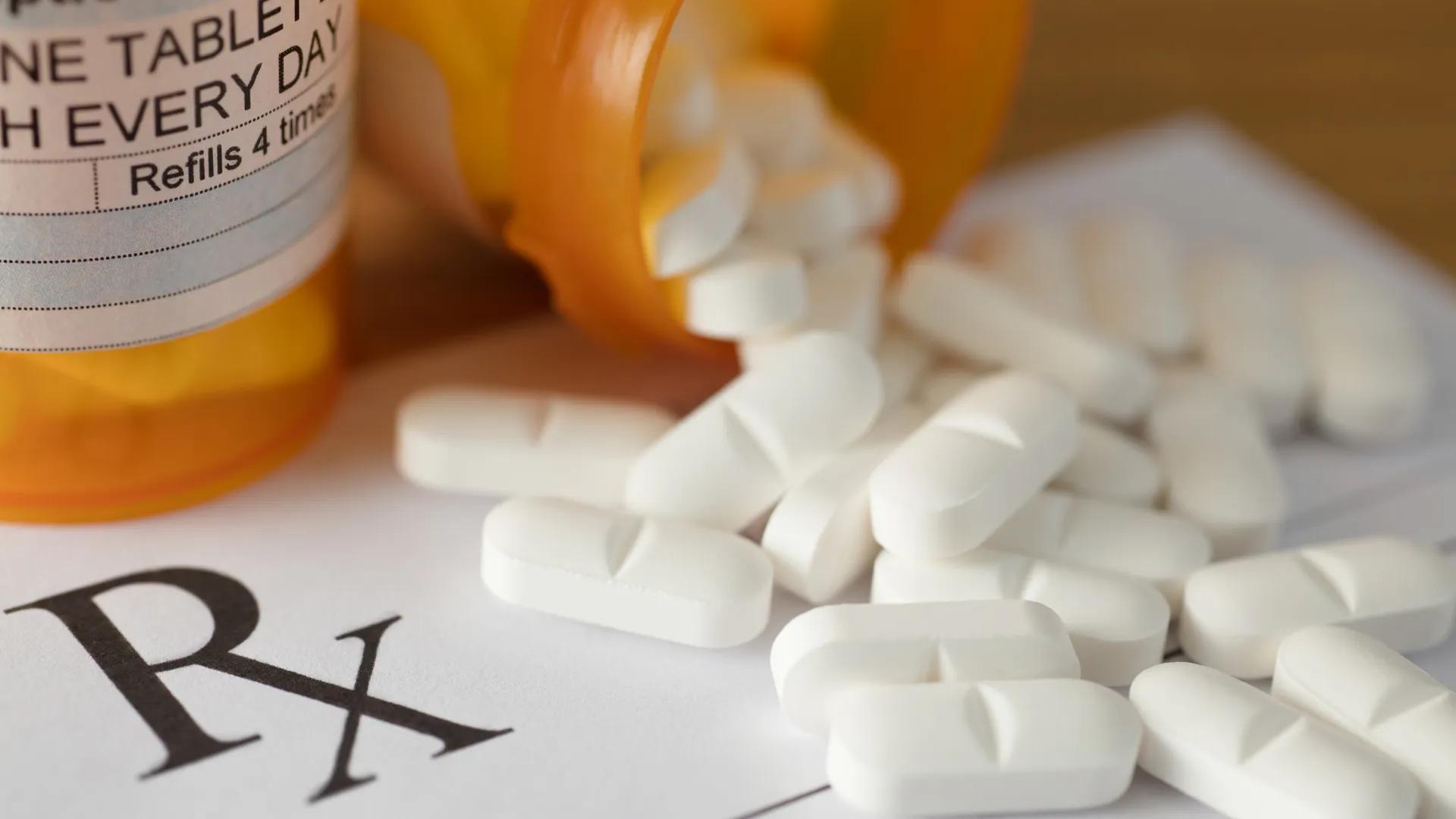Prescription bottle with medication coming out.