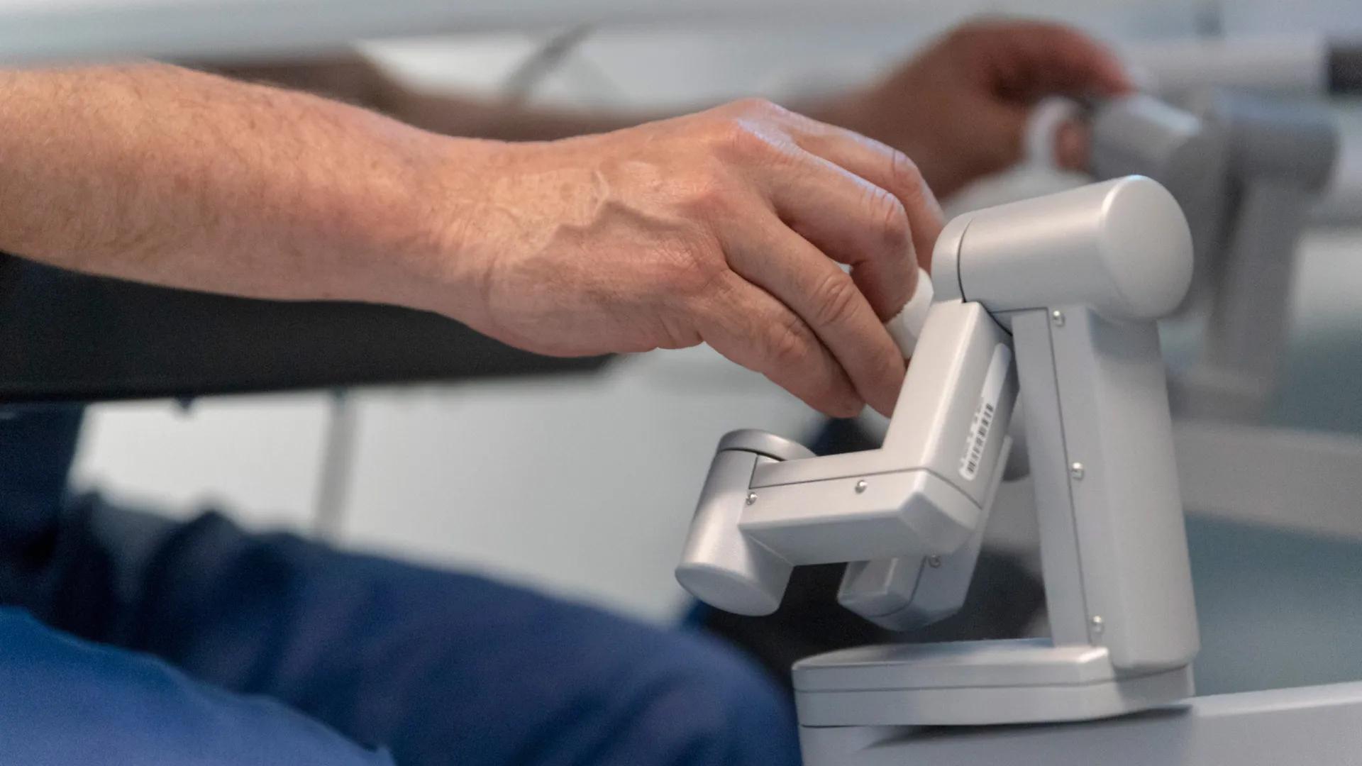 hands on a robotic handle for surgery