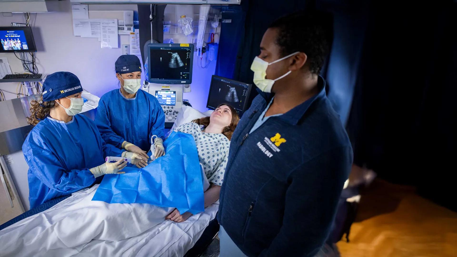 Interventional Radiologist perform a procedure on a patient.